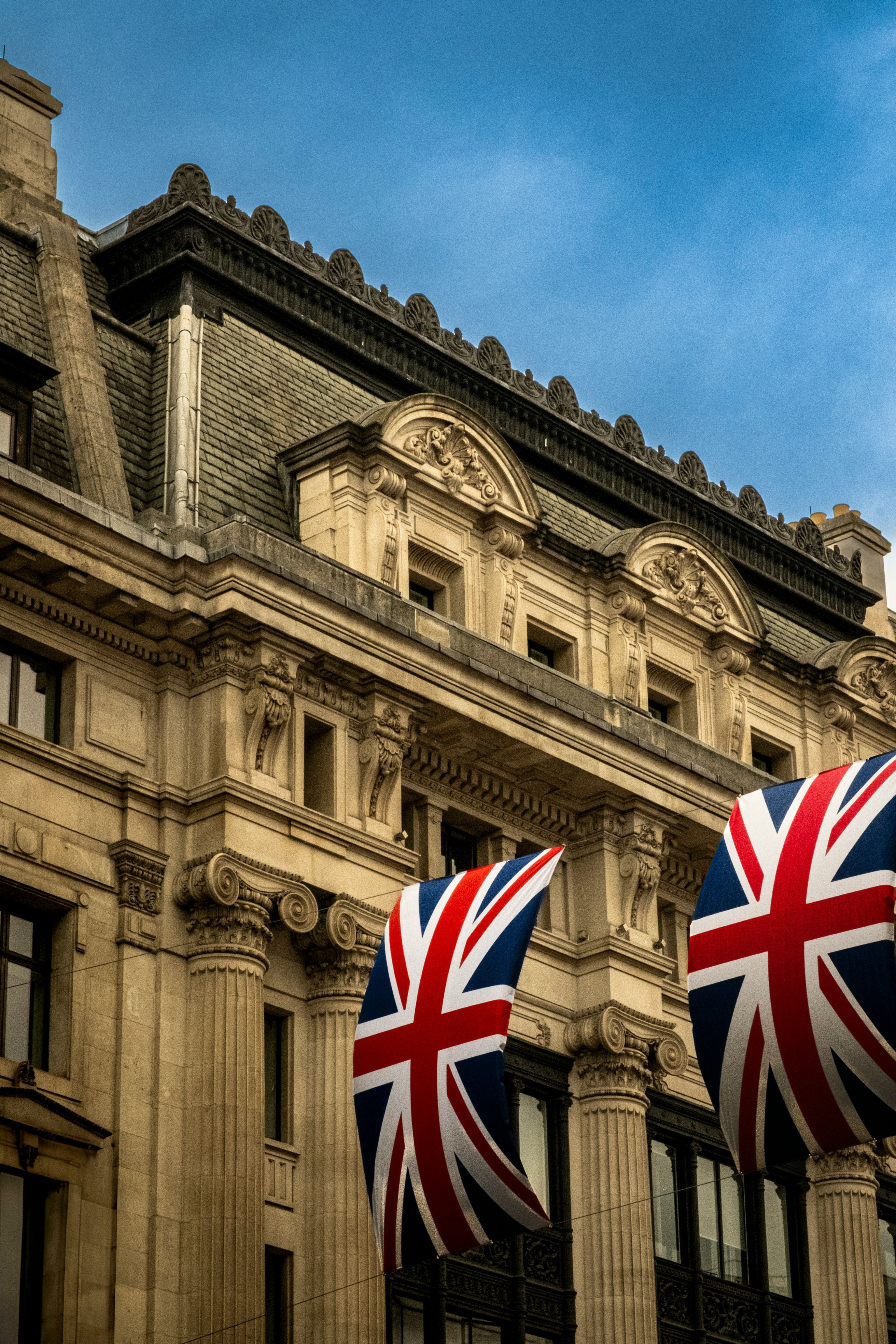 A historic building adorned with british flags.